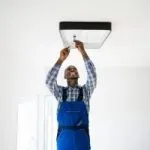 Electrician Installing Lighting Fixture